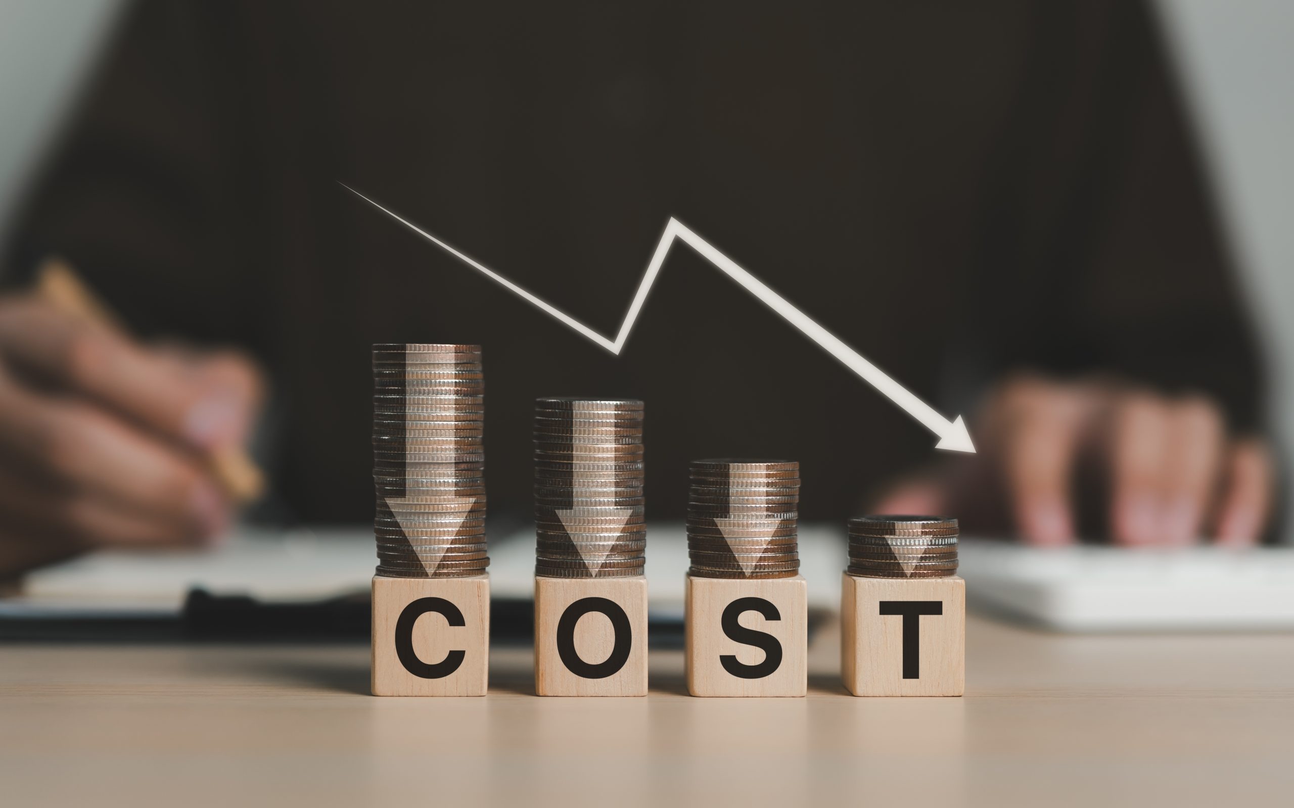 Commercial Floor Sanding in Upminster: cost-saving concept for engineered oak plank flooring projects—stacks of coins on blocks spelling COST with a downward arrow.