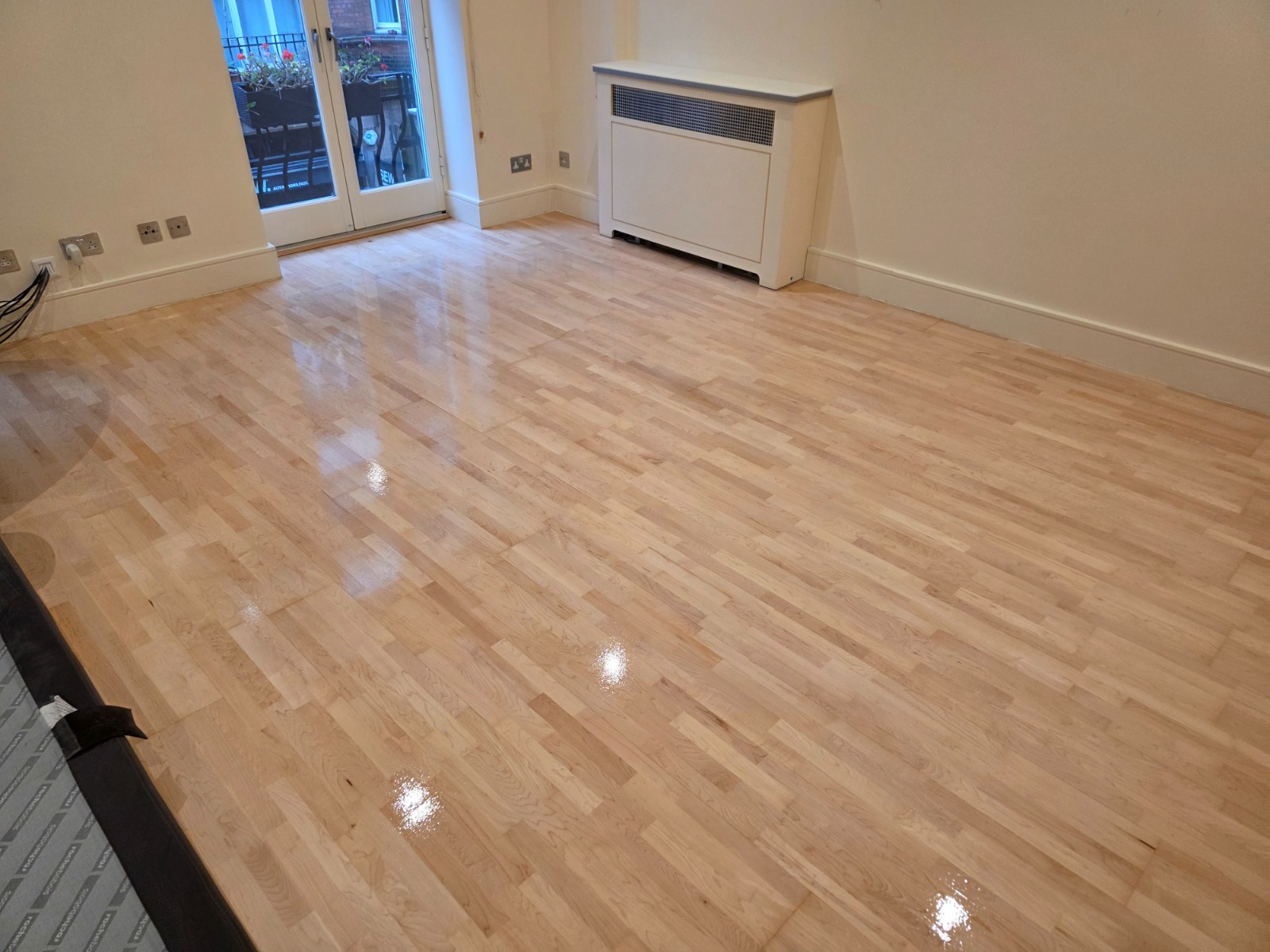 Hardwood Floor Refinishing in Upminster on a light maple hardwood block parquet living room floor restored to a smooth, glossy finish