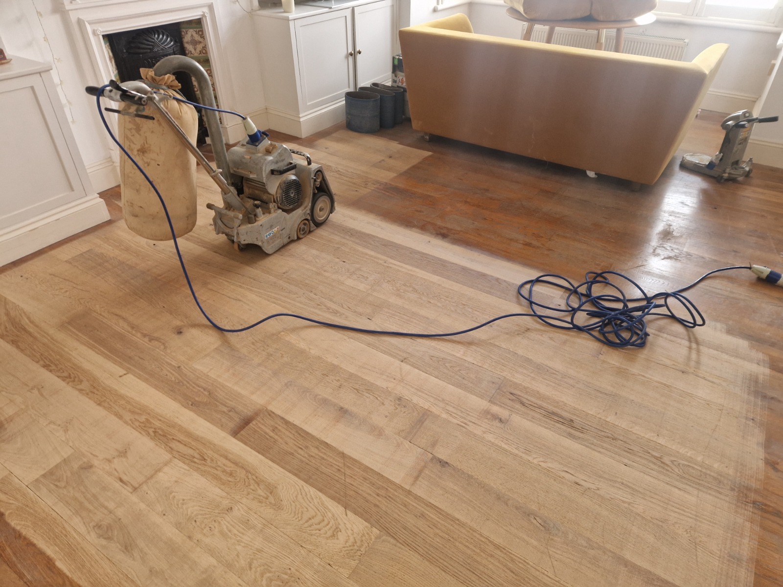 Hardwood Floor Refinishing in Upminster with a professional sander restoring an oak engineered wood plank hardwood living room floor